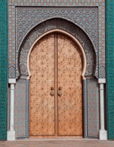 Elegant Moroccan door with intricate geometric patterns in Fes, Morocco.